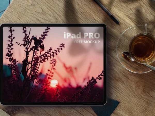iPad Pro Next to a Cup of Tea on a Wooden Desk Mockup 1