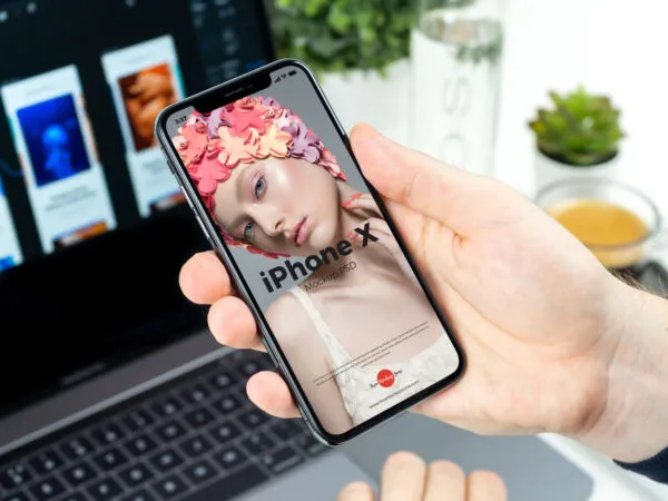 iPhone X Grabbed by Hand in Perspective Mockup 1