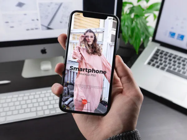 iPhone X Grabbed by Mans Hand in the Front View Mockup 1
