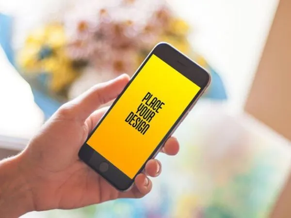 iPhone in Hand in the Perspective View Mockup 1